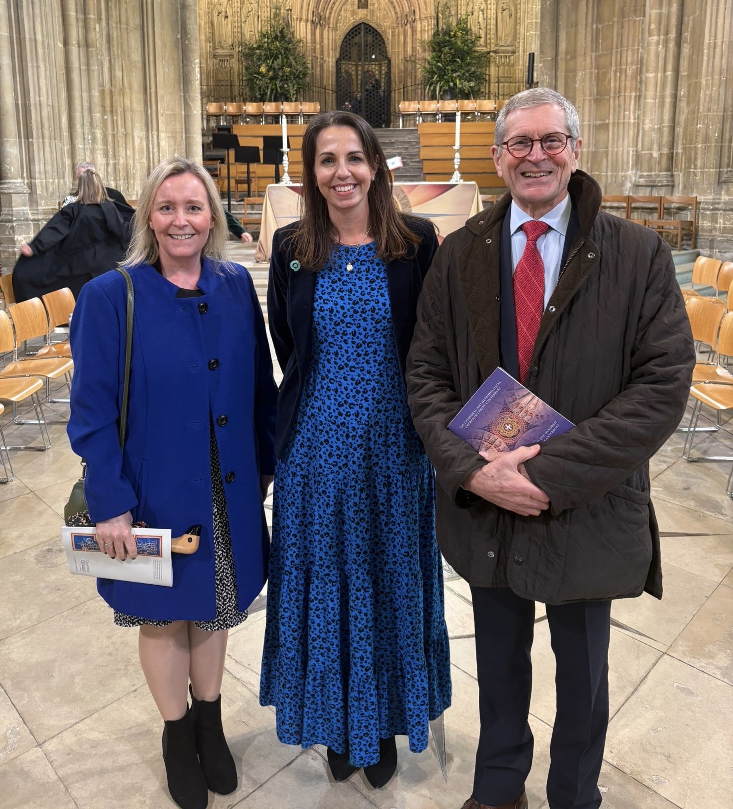 Director of Clinical Services Katie Stevens, Deputy CEO Hayley Richardson and Trustee Richard Fin in Canterbury Cathedral smiling at the camera