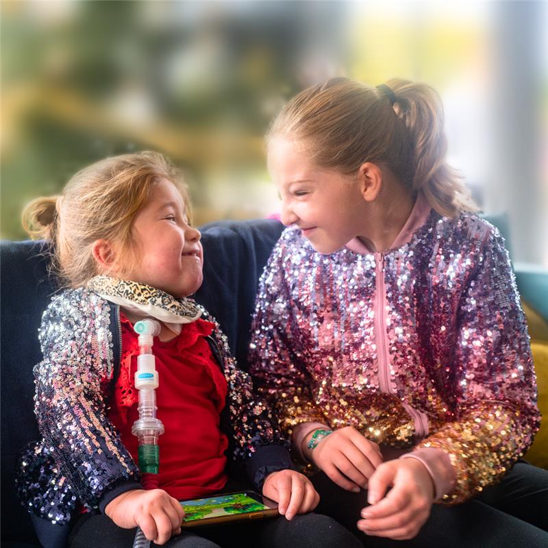 Two siblings smiling at each other