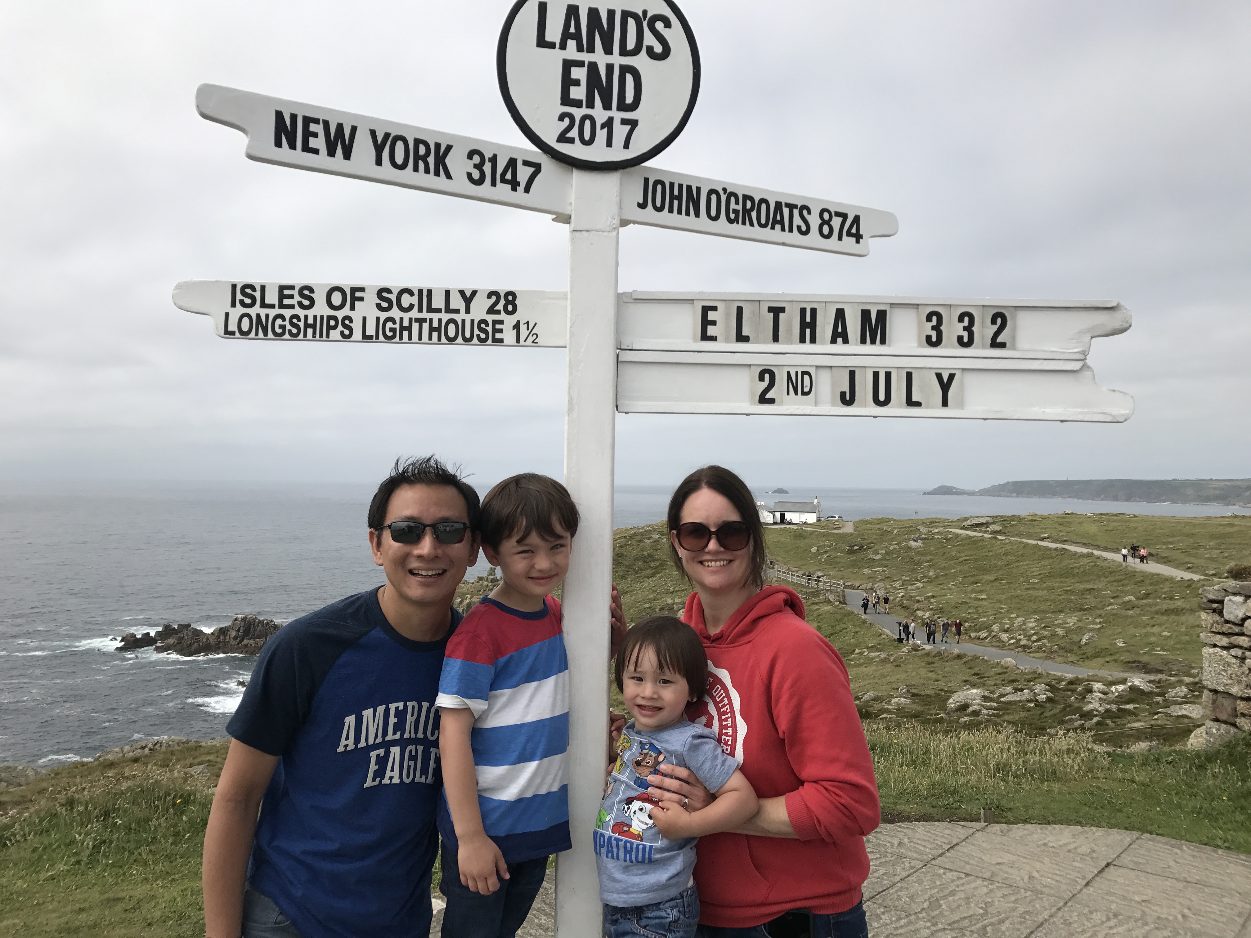 Family standing with sign
