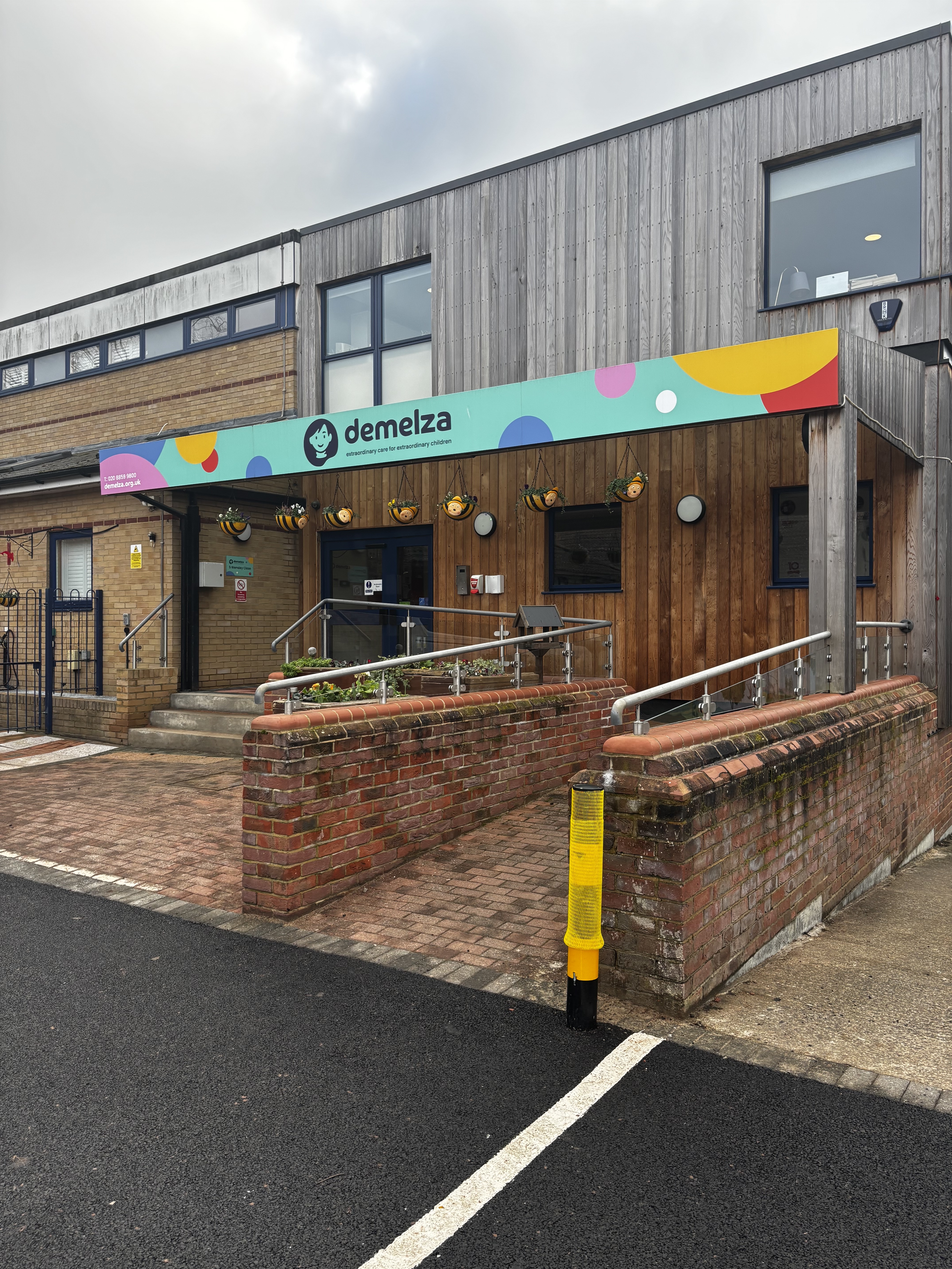 Exterior of Demelza South East London hospice with bright signage and accessible entrance, welcoming visitors.