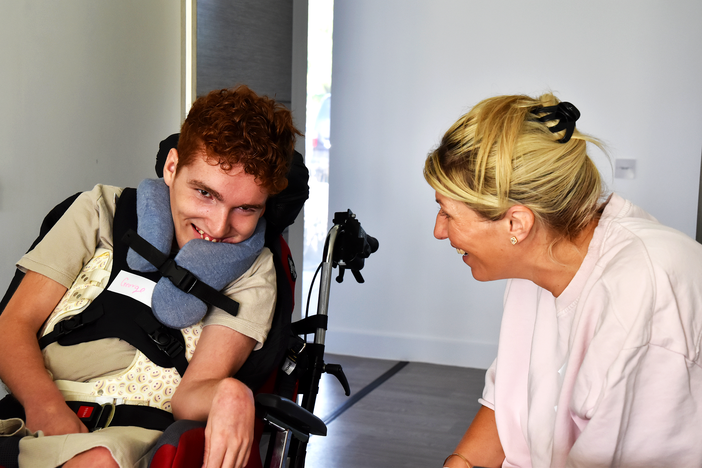 Young person and family member smiling together