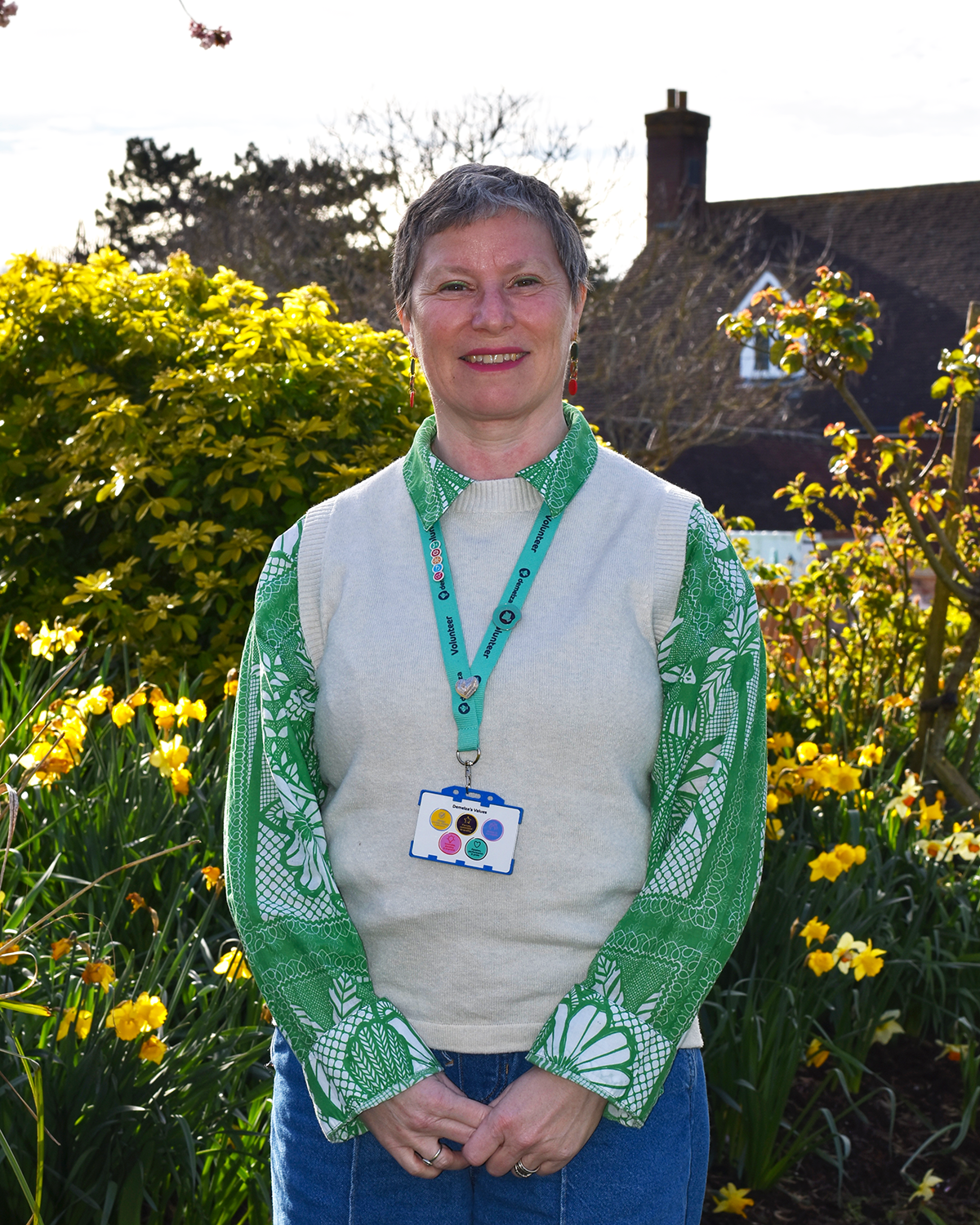 Trustee Charlotte Parry-Jones, smiling at the camera in a green and white shirt