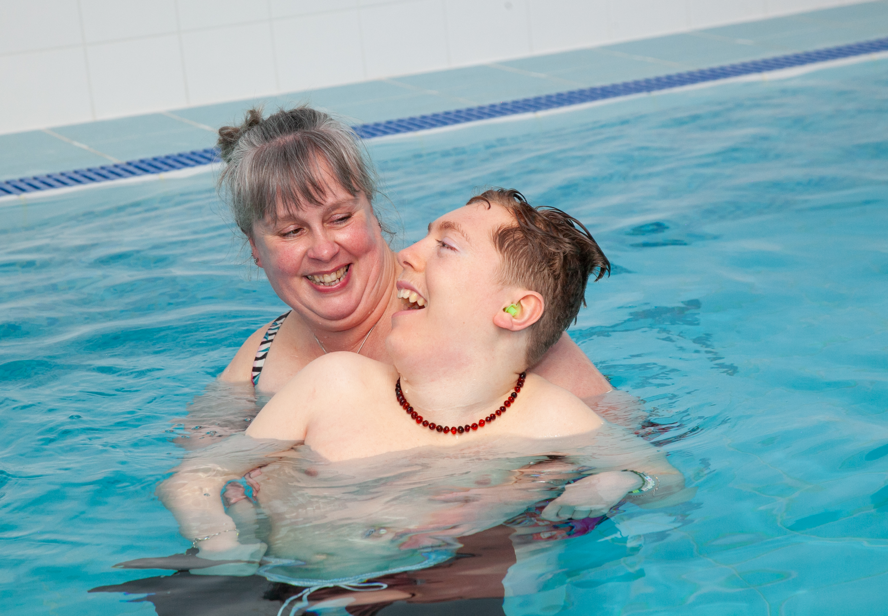 Young person and mum using hydropool