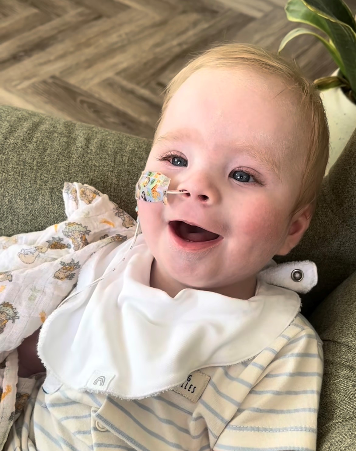 A baby with blonde hair smiling