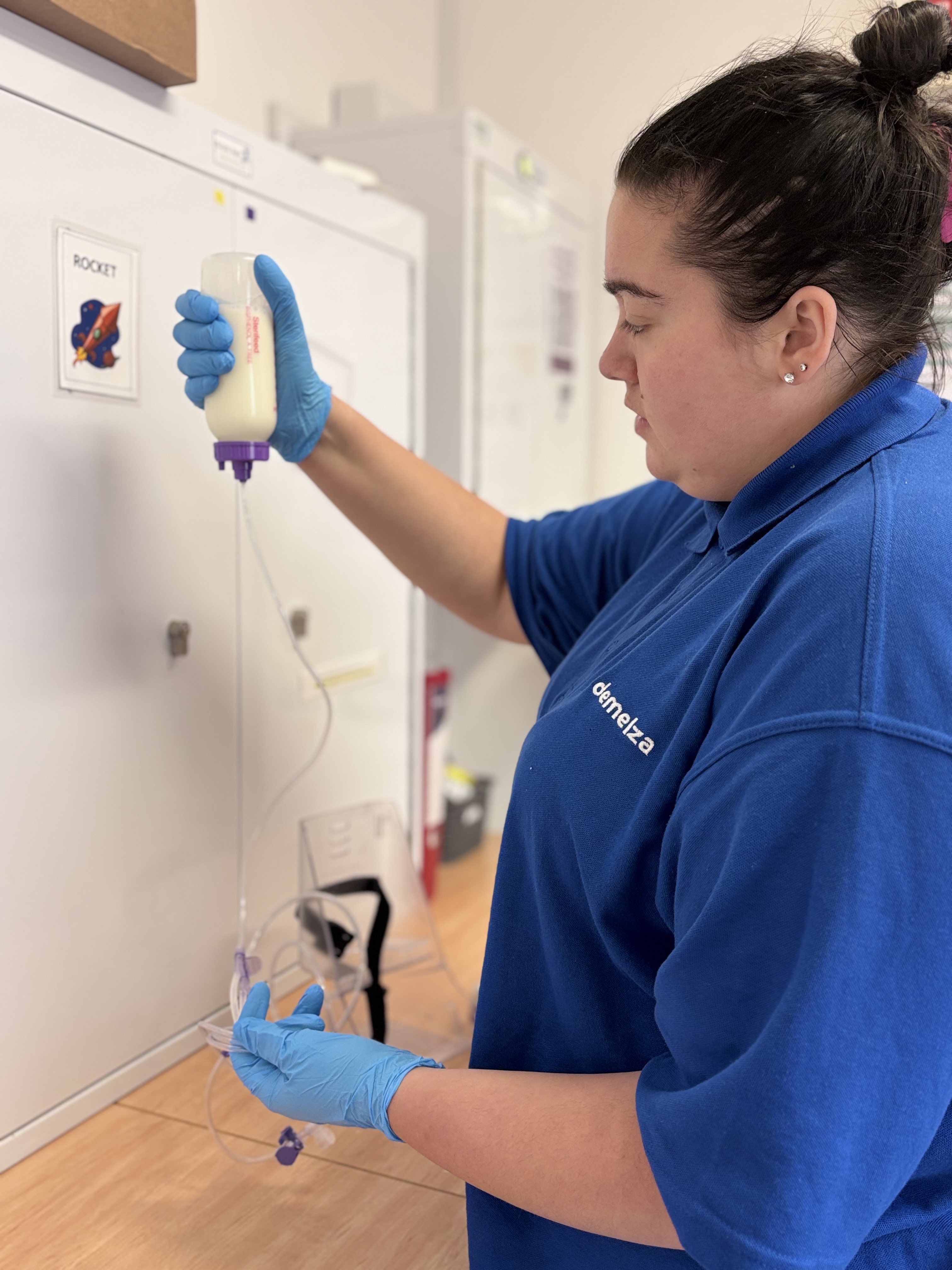 A nurse with brown hair doing clinical care work