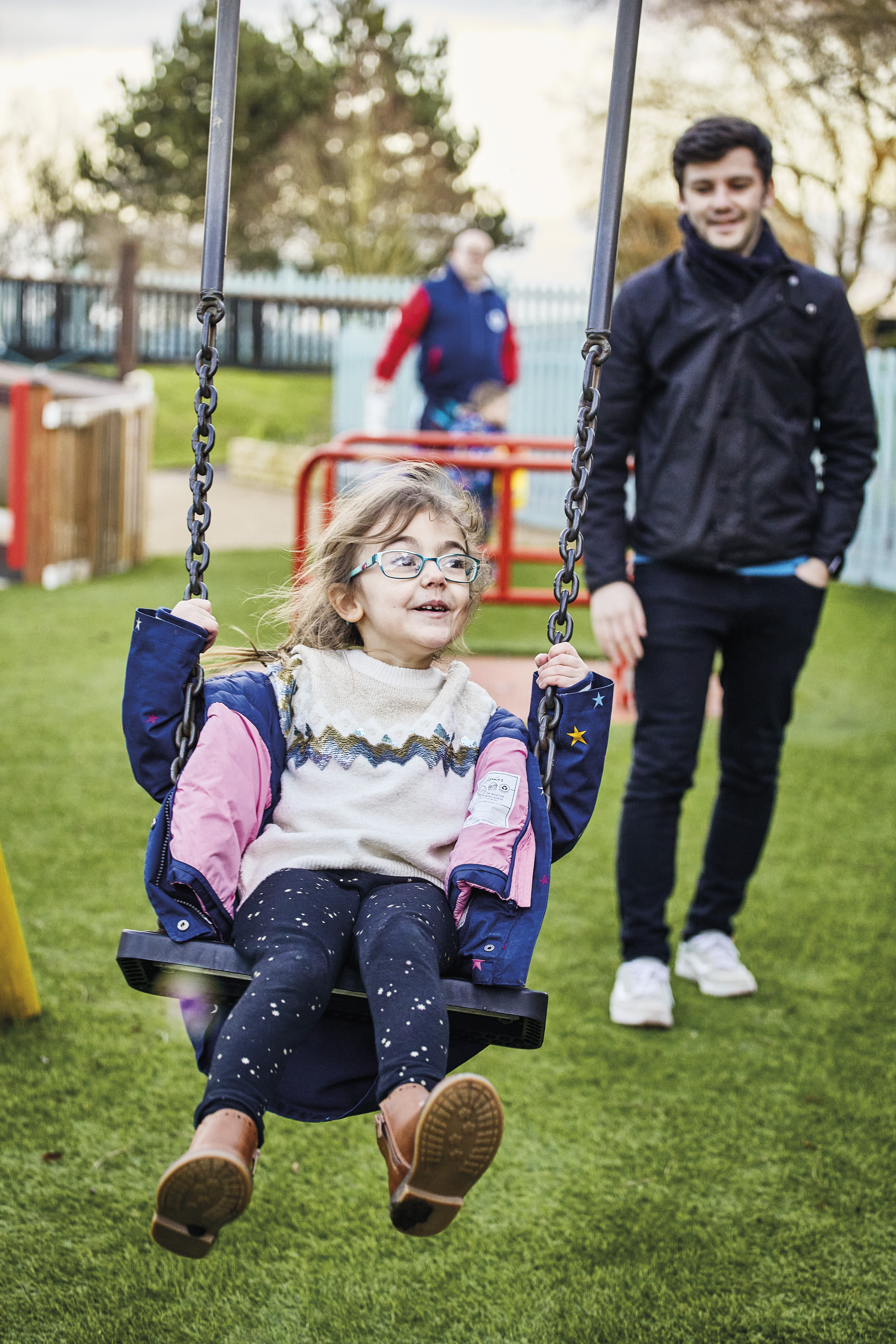Image of child using the swing in the Demelza playground