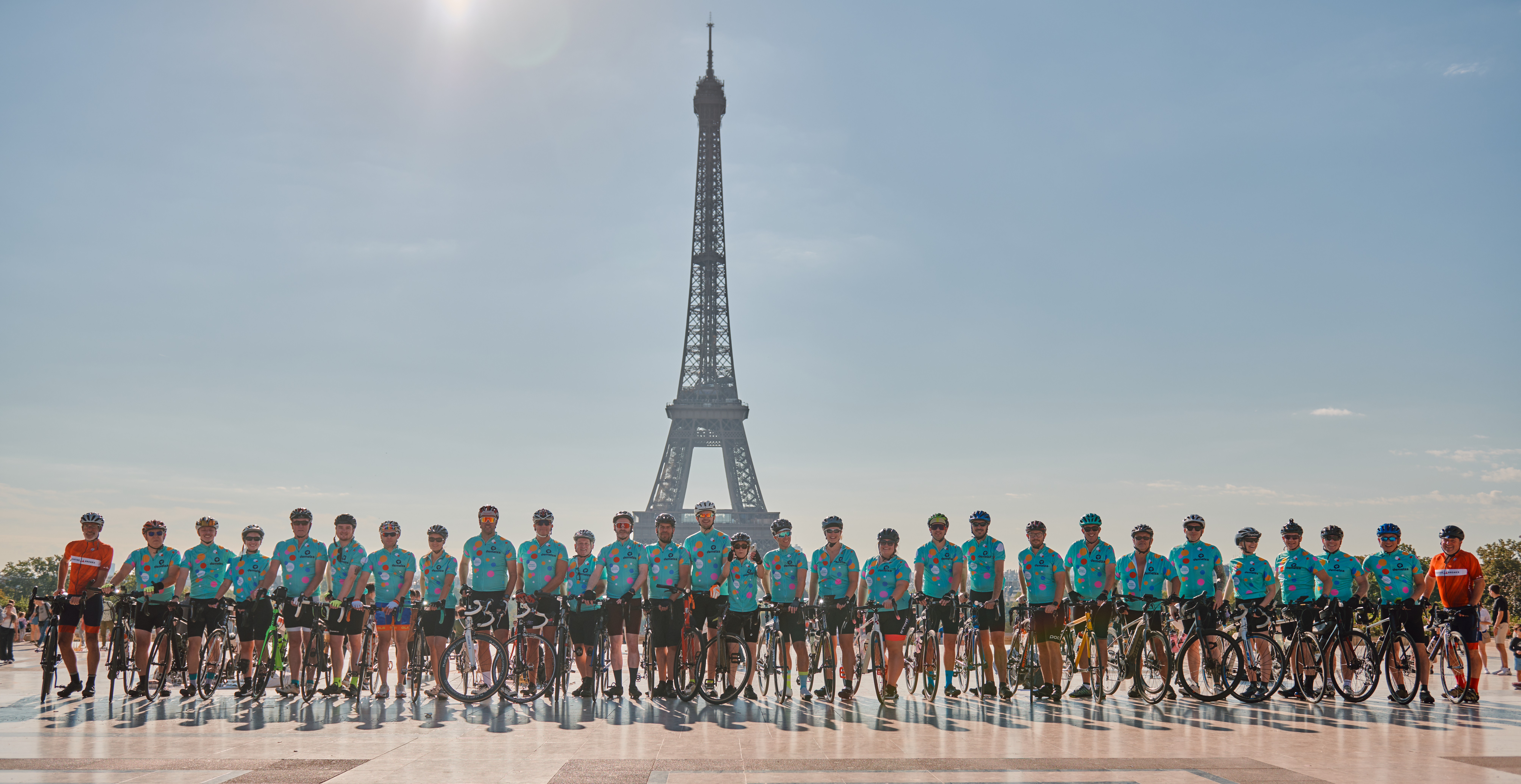 A group shot of cyclists in front of the Eiffel Tower