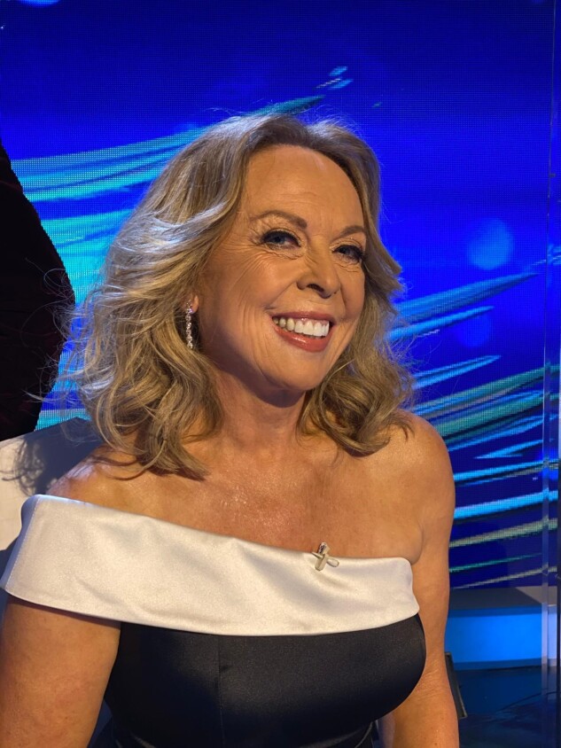 Headshot of Jayne Torvill, Demelza celebrity ambassador, smiling in a glamorous off-the-shoulder black and white gown