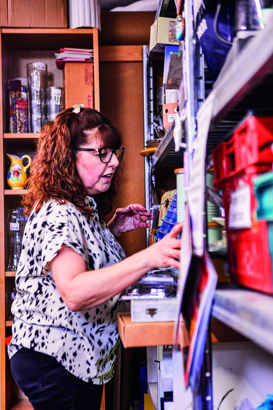 A female retail volunteer organising donated items in the back room of one of our charity shops.