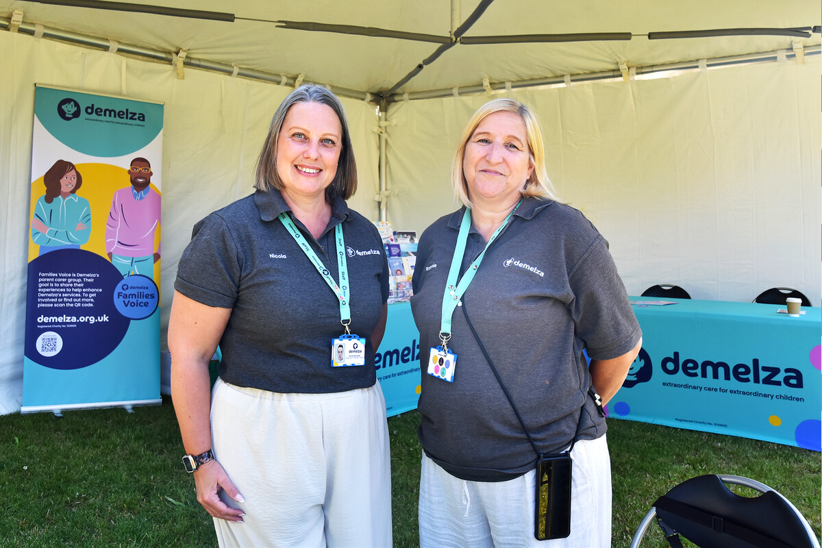 Two female members of the Family Engagement Team smiling while standing at East Sussex Discovery Day 2025