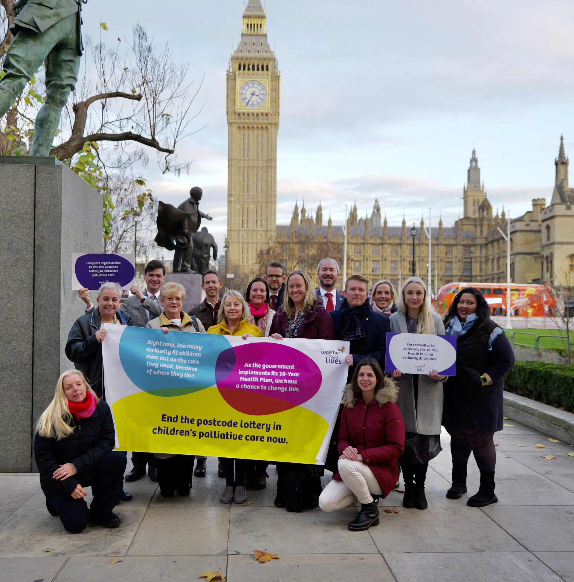 Several people outside Big Ben holding up banners and signs