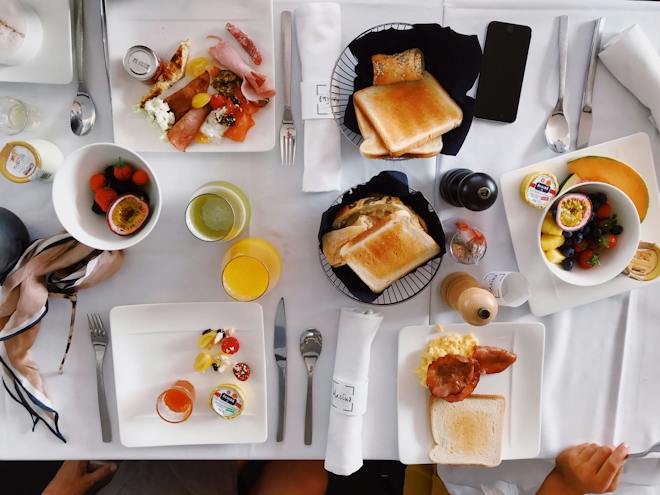 A table that has been laid out with a variety of different brunch foods and drinks